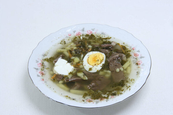 Sorrel and nettle soup with meat and egg