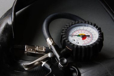 Gri arka plan lastikleri ile siyah gövdeli otomotiv manometre