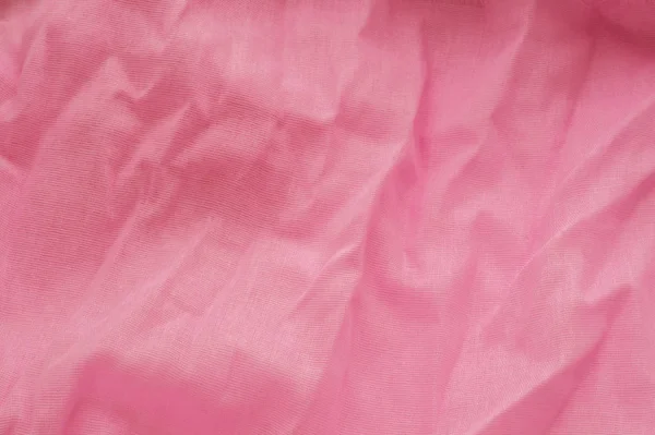 Pink background from a textile material with wicker pattern, closeup. Cloth backdrop. Crumpled fabric. Selective focus — Stock Photo, Image