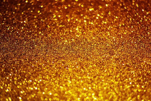 Festlich abstraktes Gold glitzert Textur Hintergrund mit glänzendem Glanz. farbenfroher defokussierter Hintergrund mit glitzernden und funkelnden Flecken. passend für Weihnachten, Neujahr, chinesisches Neujahr und Designs — Stockfoto
