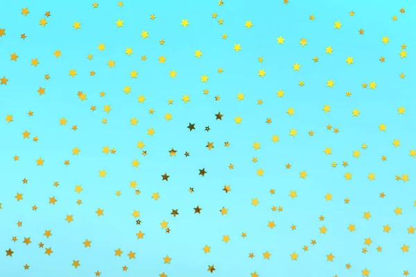 Az arany csillagok pasztell kék háttérként szórnak. Ünnepi ünnepek. a projektekhez. Ünneplés koncepció. Karácsonyi minta. Felülnézet, lapos Lay — Stock Fotó