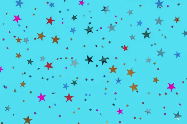 Conceito de celebração. Foto de estrelas multicoloridas polvilha no fundo azul. Fundo festivo de férias para seus projetos. Padrão de Natal. Vista superior, flat lay — Fotografia de Stock