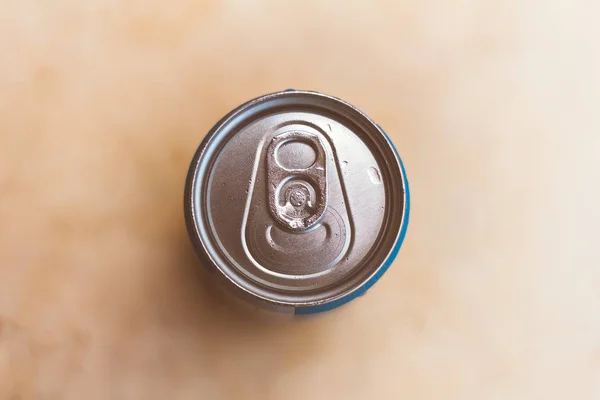 Top of a beer can or soda. Background blurred.