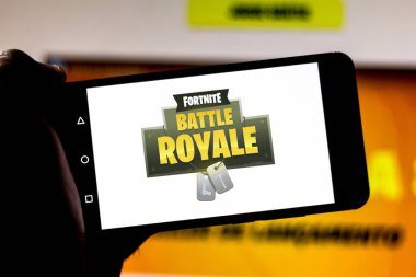 April 1, 2019, Brazil. Logo Fortnite Battle Royale on the screen of the mobile device. Fortnite is an online multiplayer online game developed by Epic Games clipart