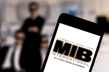 Men in Black International (MIB) logo on the mobile device. The MIB is an American action and science fiction film distributed by Columbia Pictures clipart