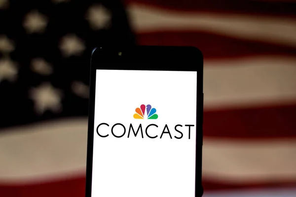 May 16, 2019, Brazil. In this photo illustration the Comcast Corporation logo is displayed on a smartphone — Stock Photo, Image