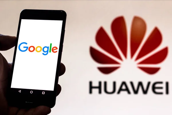 30 juni 2019, Brazilië. In deze foto illustratie persoon houdt smartphone met Google-logo en op de achtergrond het Huawei-logo — Stockfoto