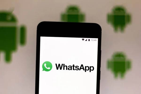 July 9, 2019, Brazil. In this photo illustration the WhatsApp logo is displayed on a smartphone. In the background, Android logo — Stock Photo, Image