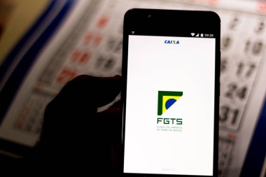 July 26, 2019, Brazil. In this photo illustration the app FGTS (Fundo de Garantia do Tempo de Serviço) is displayed on a smartphone clipart