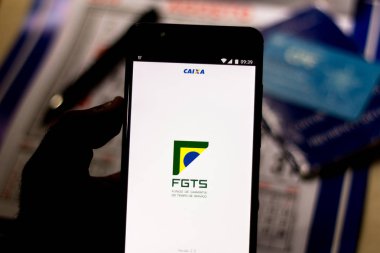 July 26, 2019, Brazil. In this photo illustration the app FGTS (Fundo de Garantia do Tempo de Serviço) is displayed on a smartphone clipart