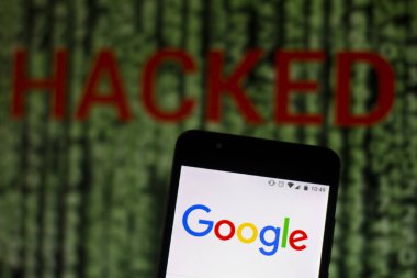 10 Ağustos 2019, Brezilya. Bu fotoğraf illüstrasyonunda Google logosu bir akıllı telefonda ve bulanık arka planda Hacked sözcüğünde kırmızı uyarıda görüntülenir. Veri ihlali için kavramsal fotoğraf