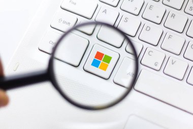 October 3, 2019, Brazil. In this photo illustration the Microsoft Windows logo is displayed through a magnifying glass clipart