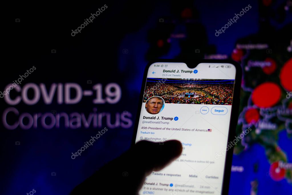 June 5, 2020, Brazil. In this photo illustration the official page of the President of the United States, Donald Trump, on Twitter seen displayed on a smartphone. In the background, interactive map with the cases of COVID-19 (coronavirus).