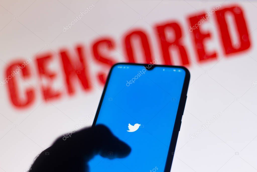June 15, 2020, Brazil. In this photo illustration the Twitter logo is displayed on a smartphone and red alerting word CENSORED on the blurred background.