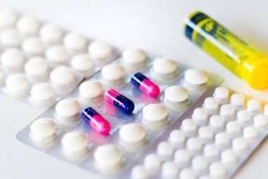 In this photo illustration pharmaceutical pills are seen displayed on a table.Dexamethasone, Hydroxychloroquine are used to treat coronavirus (COVID-19) disease clipart