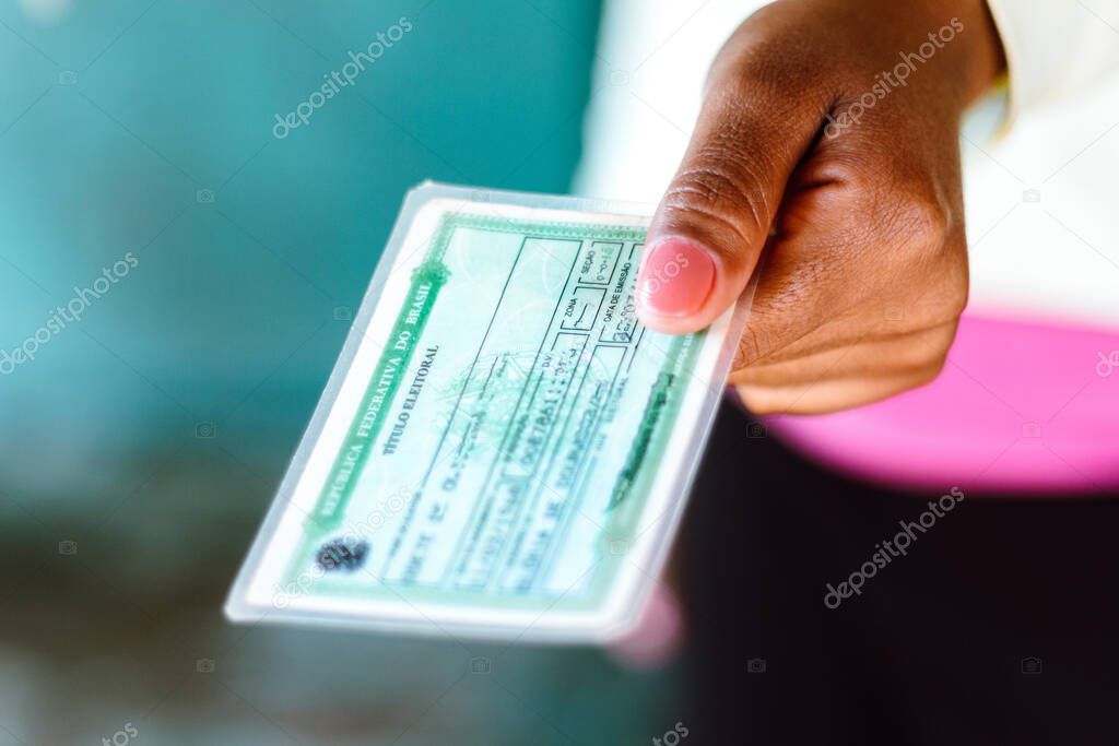 July 4, 2020, Brazil. Woman holds the Voter License (Titulo Eleitoral). It is a document that proves that the person is able to vote in Brazil elections