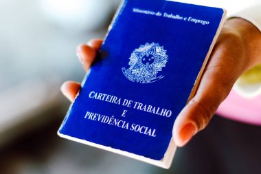 4 Temmuz 2020, Brezilya. Kadın, Brezilya belgelerini ve sosyal güvenceyi elinde tutmaktadır (Carteira de Trabalho e Previdencia Social)