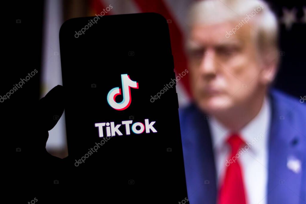 August 1, 2020, Brazil. In this photo illustration the TikTok logo seen displayed on a smartphone. United States President Donald Trump appears in the background. He said he will ban TikTok in the USA