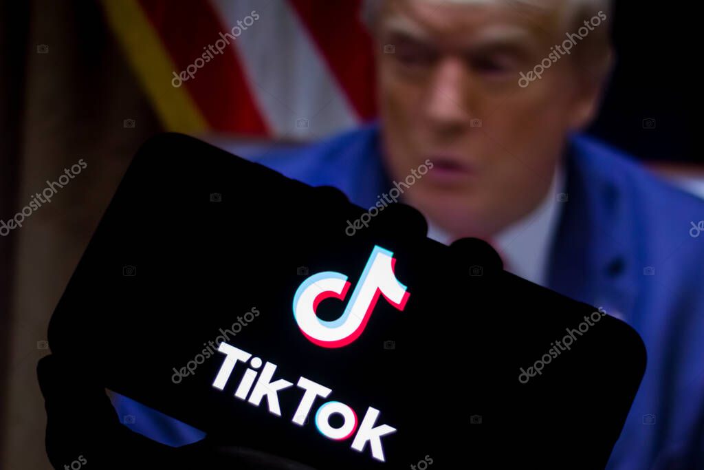 August 1, 2020, Brazil. In this photo illustration the TikTok logo seen displayed on a smartphone. United States President Donald Trump appears in the background. He said he will ban TikTok in the USA