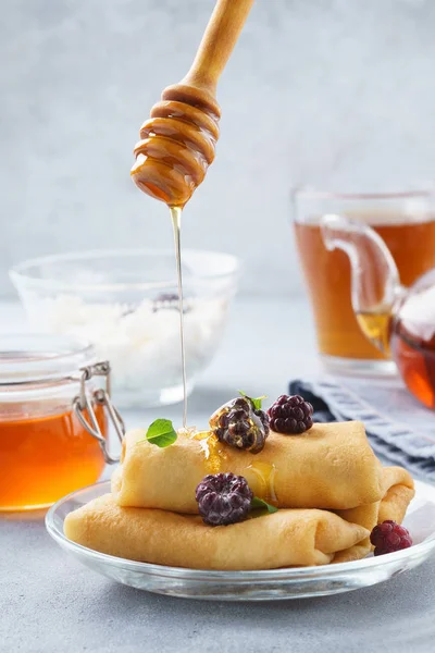 Crepes with ricotta filling served with honey, blackberries and mint.