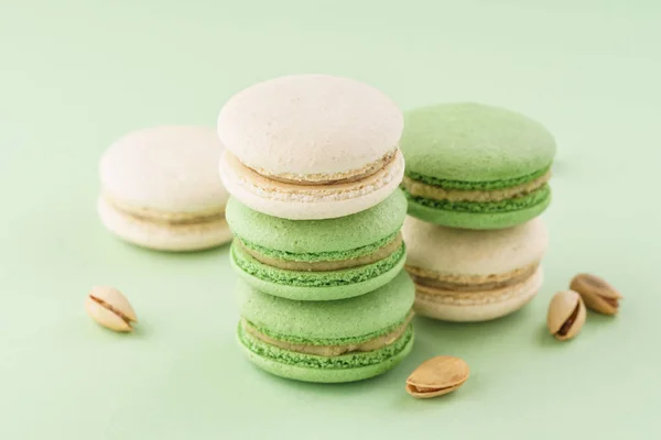 Stack of pistachio macarons on green background. — Stock Photo, Image
