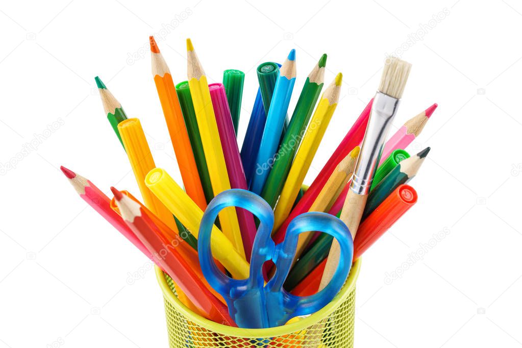 Colored pencils and various stationery in a holder. Isolated.