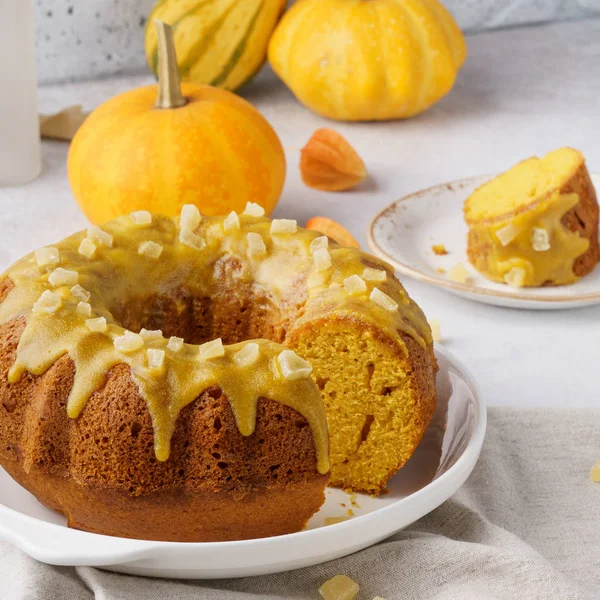 A piece of sweet pumpkin bundt cake topped with sugar glaze.