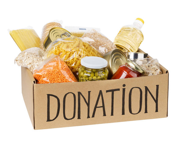 Open cardboard box with oil, canned food, cereals and pasta.