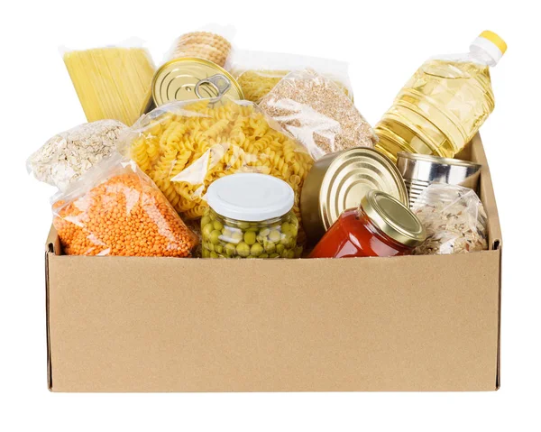 Various canned food, pasta and cereals in a cardboard box. — Stock Photo, Image