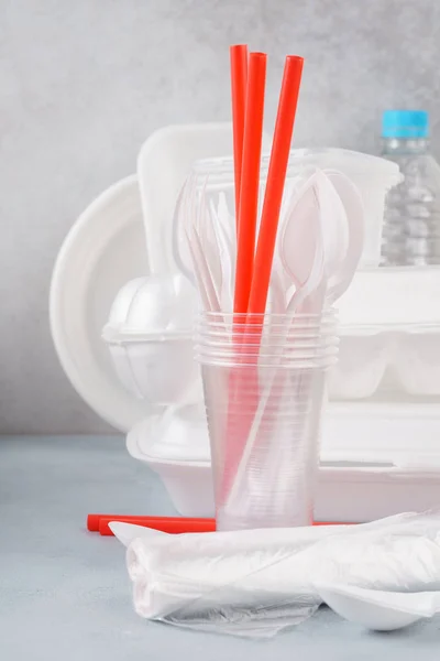 Set of white plastic disposable tableware and packaging.