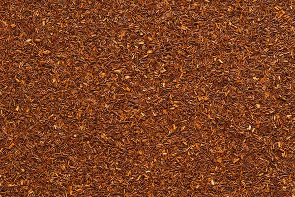 Foglie di tè Rooibos secche come sfondo . — Foto Stock