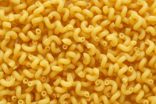 Dry uncooked cavatappi or cellentani pasta as a background. — Stock Photo, Image