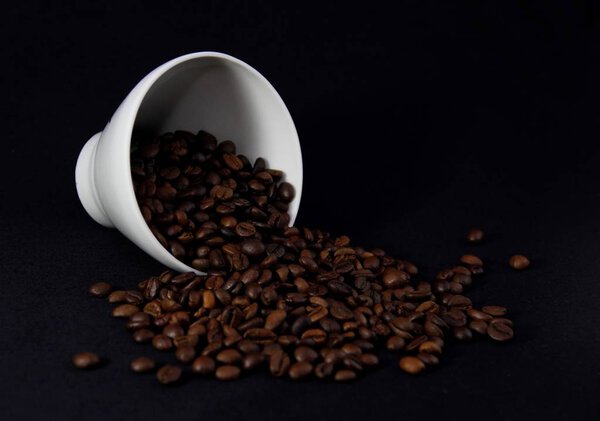 coffee beans and Cup on black background