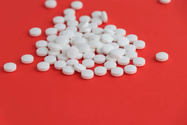 Tablets medicine for peoples health to heal diseases, top view of the Spilled white pills on the white surface. — Stock Photo, Image