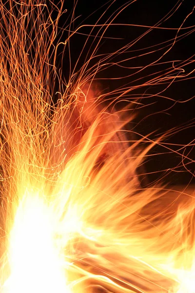Fire with sparks on a black background. — Stock Photo, Image