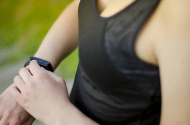 Genç bir kız fitness takip cihazı kullanır. Akıllı Saat.