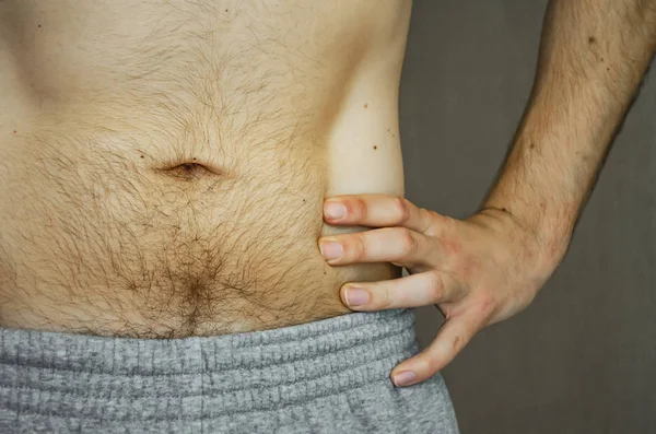 The hairy belly of a young man. — Stock Photo, Image