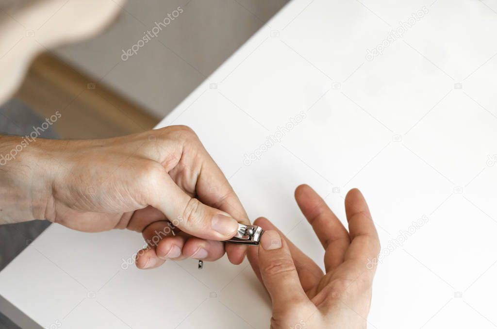 A young man does a manicure. Photo.