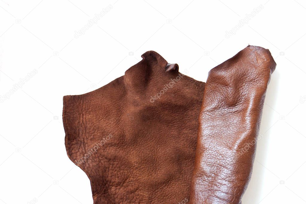 Brown leather in roll isolated on white background. Materials for leather craft. Copy space. Top view. Handmade craft. Isolated on white