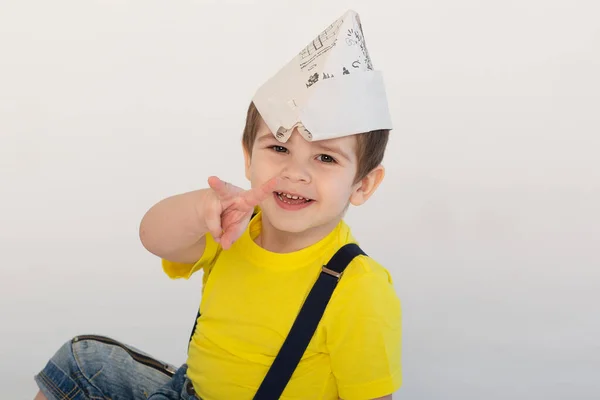 Small Boy Construction Clothes Newspaper Cap Laughs Points Number Two — Stock Photo, Image