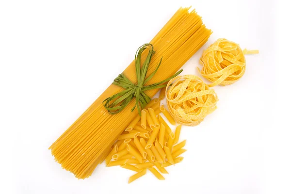 Raw Pasta with ingredients on white background. Top view