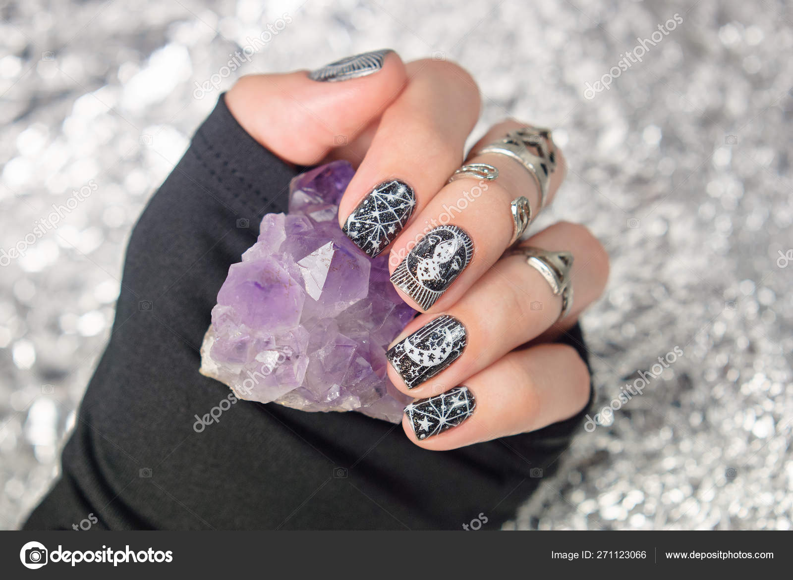 Black gothic manicure with mystic nail art. Amethyst in the hand on the  silver sparkle background. Stock Photo by ©irina_zorg 271123066
