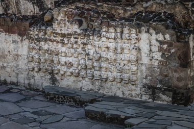 Tzompantli altar with carved Skulls rows in Aztec Temple (Templo Mayor) at ruins of Tenochtitlan - Mexico City, Mexico clipart