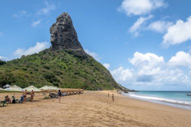 Fernando de Noronha - Oct 7, 2017: Beach Umbrellas at Praia da Conceicao Beach and Morro do Pico - Fernando de Noronha, Pernambuco, Brazil