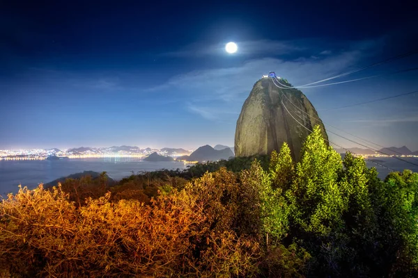 Sugar Loaf Mountain at night with a full moon - Rio de Janeiro, Brazil
