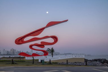 SANTOS, BRAZIL - Sep 3, 2017: Sculpture by Tomie Ohtake at Marine Outfall (Emissario Submarino) at sunset - Santos, Sao Paulo, Brazil clipart