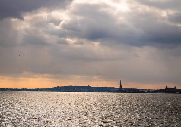 Statue of Liberty silhouette and Liberty Island - New York, USA