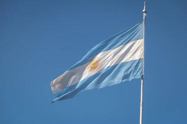 Arjantin bayrağı sallayarak üzerinde mavi bir gökyüzü