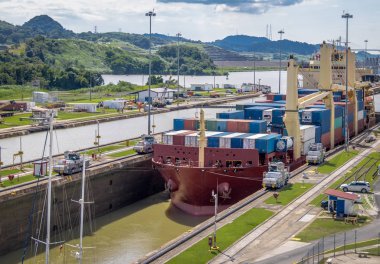 Ship crossing Panama Canal being lowered at Miraflores Locks - P clipart