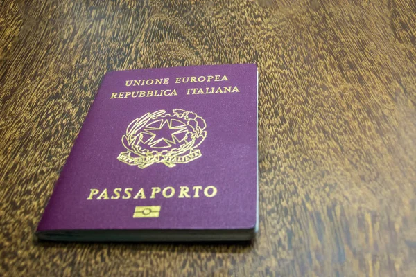 Italian passport on wooden background